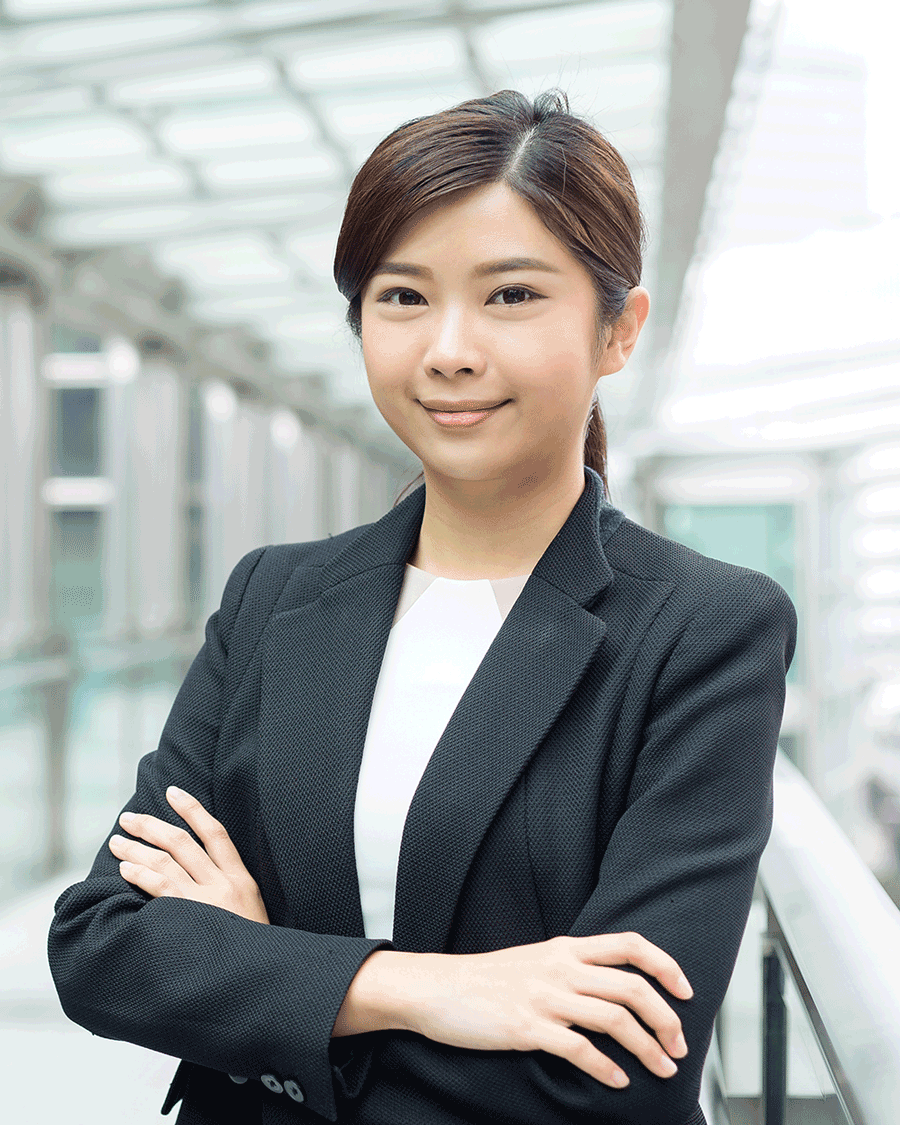 A woman in business attire with her arms crossed.