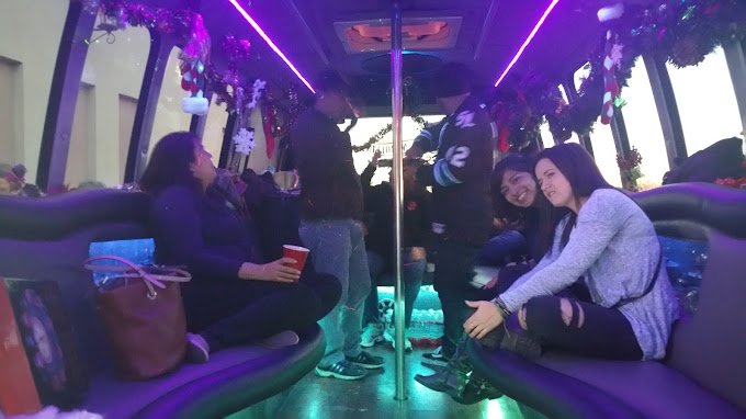 A group of people sitting on the back of a bus.