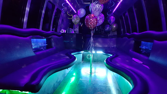 A party bus with purple seats and lights