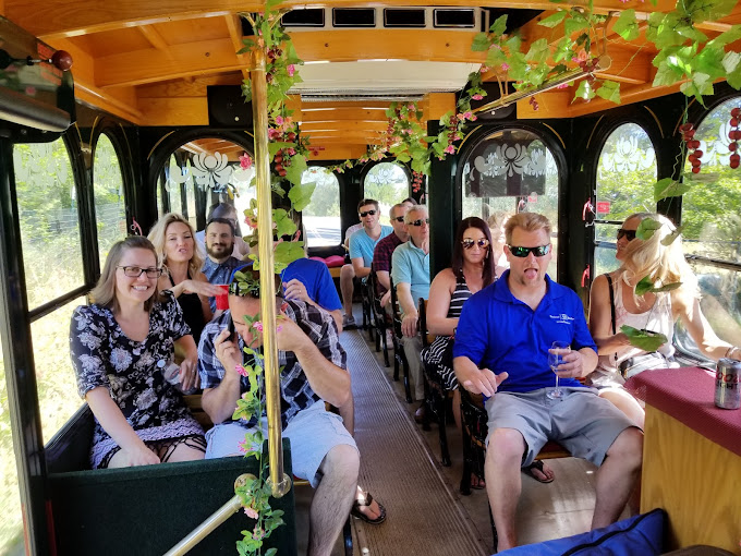 A group of people sitting on top of a bus.