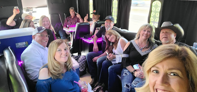 A group of people sitting on the back of a bus.