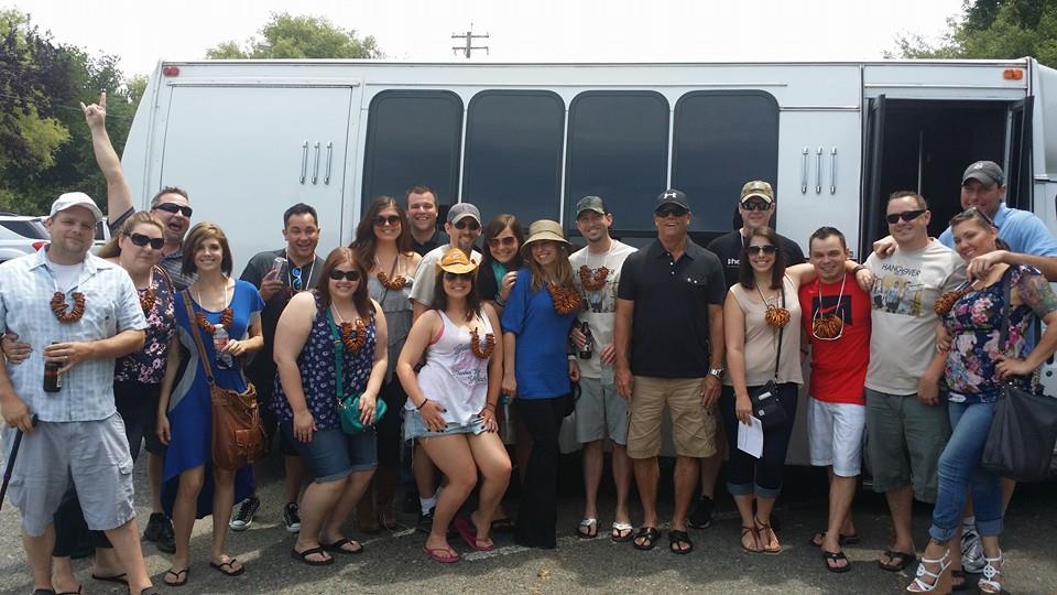 A group of people standing in front of a bus.