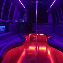 A purple lit up bus with red lights