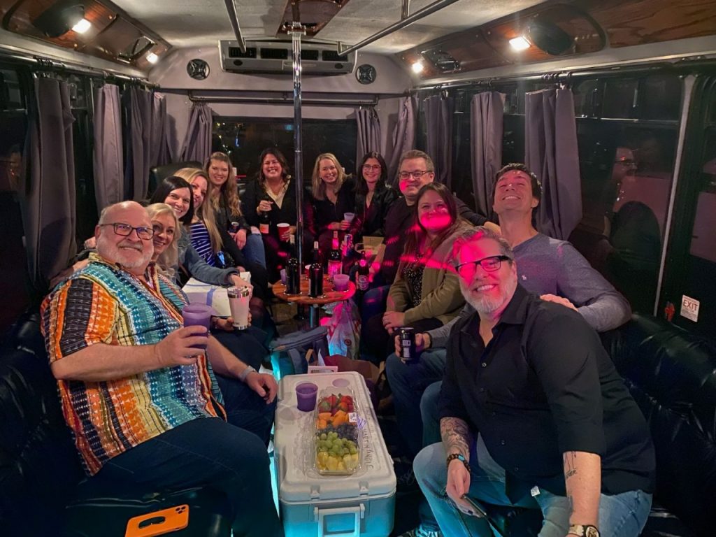 A group of people sitting on top of a bus.