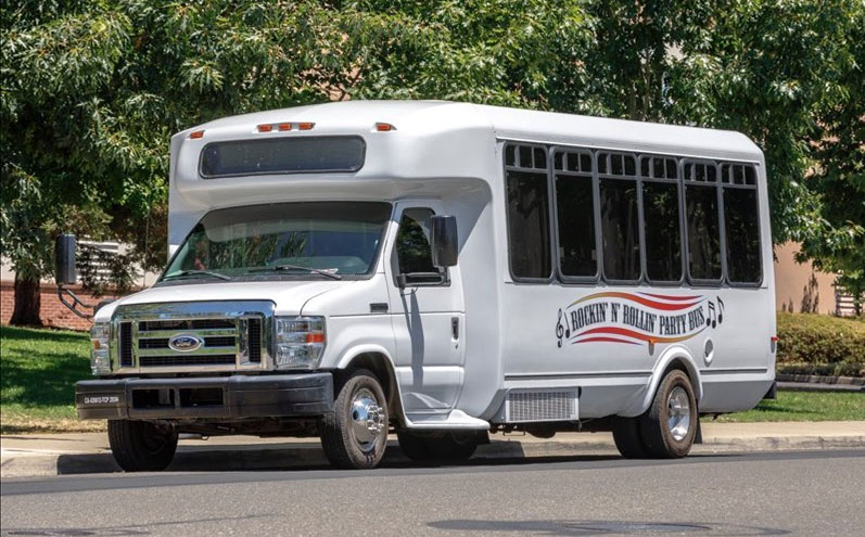 A white bus is parked on the street