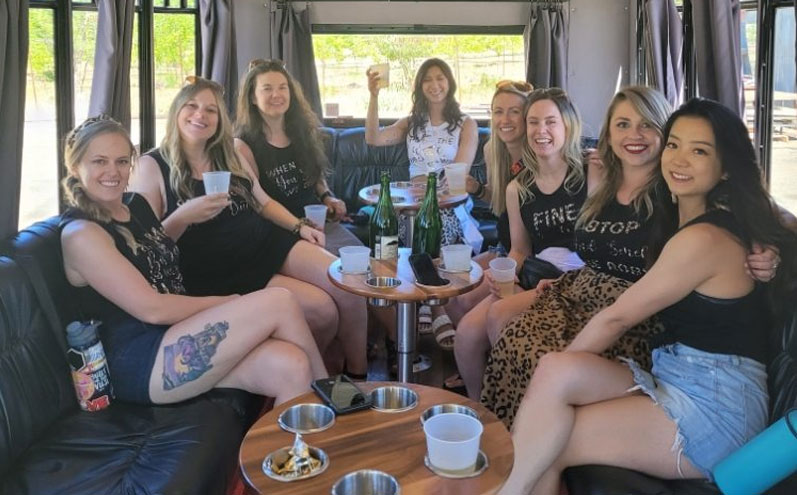 A group of women sitting on top of a couch.