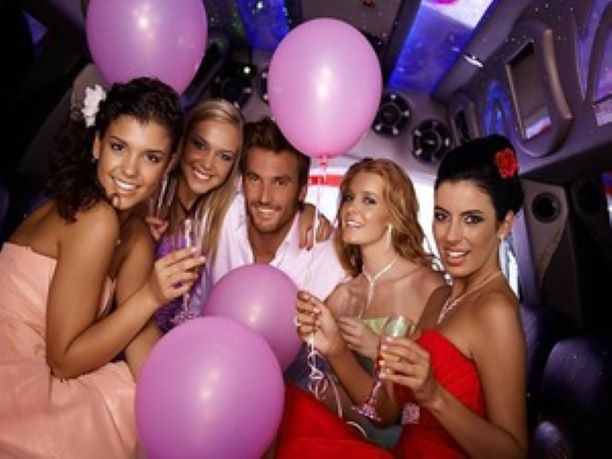 A group of people holding balloons and drinking champagne.